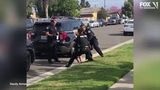 Police officers stop fellow officer punching handcuffed woman during arrest [upl. by Koralle]